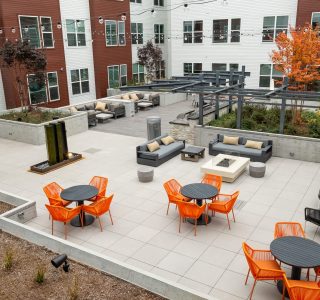 Studio 3807 Courtyard with multiple tables and grilling kitchen
